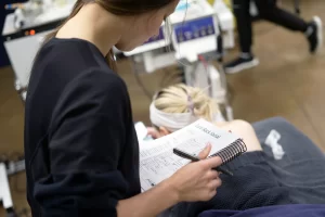Student giving back facial